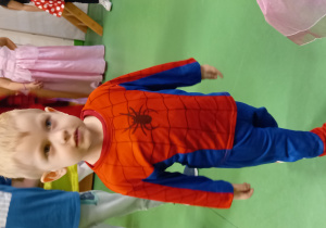 Chłopiec przebrany za Spidermana ładnie prezentuje się do zdjęcia.