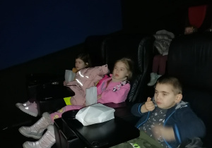 Dzieci oglądają film.